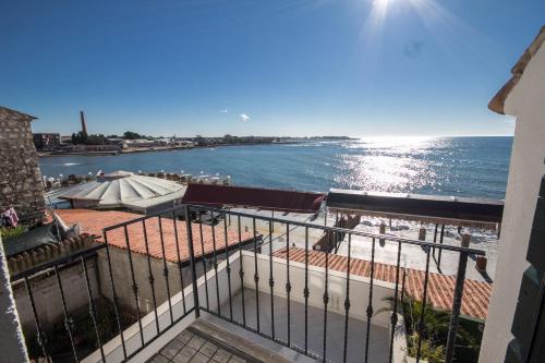 a view of the ocean from a balcony of a building at Apartments Umag Center, seafront with terrace in Umag in Umag
