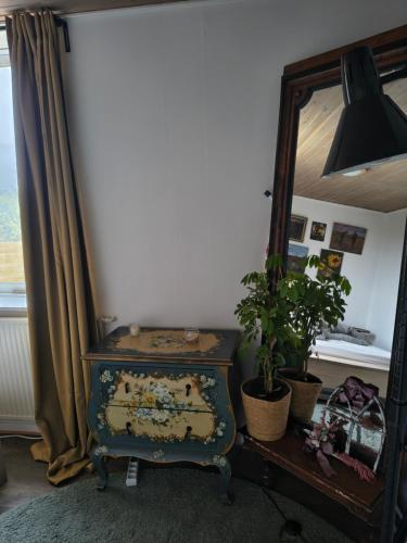 a room with a mirror and an old dresser and a dresser with at Cozy guest house with terrace in Aalborg