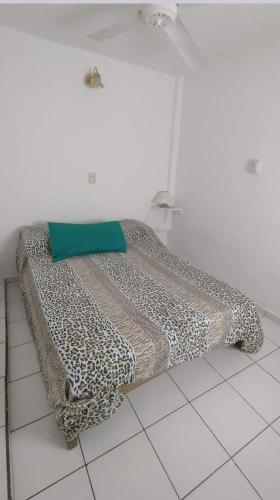 a bed sitting on a tiled floor in a room at Complejo el Cuy in Las Grutas
