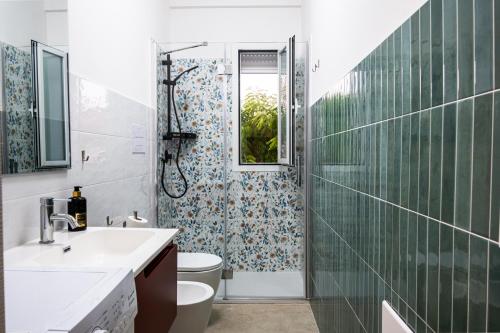 a bathroom with a shower and a sink and a toilet at Residence Casuzze in Marina di Ragusa