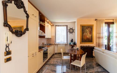 a kitchen with a table and a dining room at Villa Infinity Garda in Peschiera del Garda