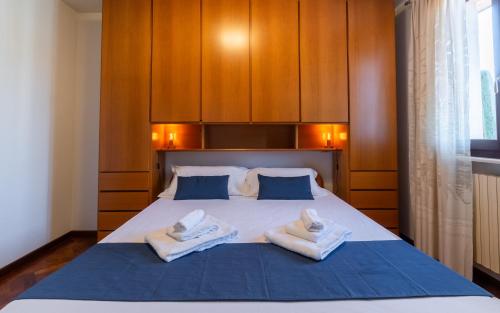a bedroom with a bed with two towels on it at Villa Infinity Garda in Peschiera del Garda