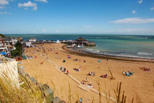 a group of people on a beach near the ocean at Sunshine Villa Broadstairs sleeps 8 close to beach in Broadstairs