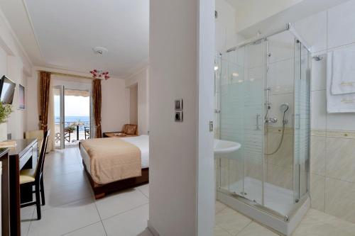 a hotel room with a shower and a bedroom at Ilia Mare in Ilia