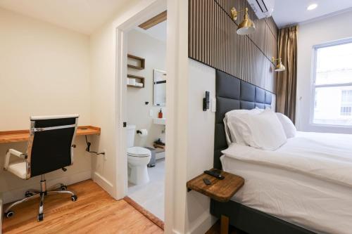a bedroom with a bed and a desk and a computer at The Inn at Dupont in Washington, D.C.
