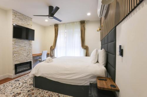 a bedroom with a large bed and a fireplace at The Inn at Dupont in Washington, D.C.