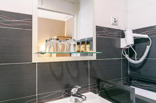 a bathroom with a sink and a mirror at Vila Nova Guesthouse in Lisbon