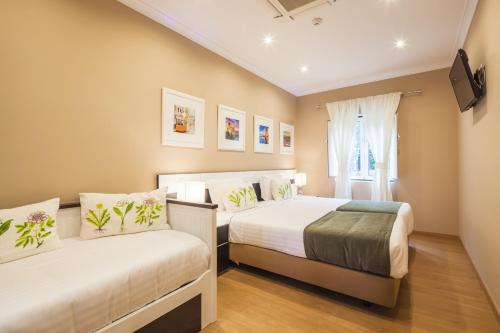 Säng eller sängar i ett rum på Vila Nova Guesthouse