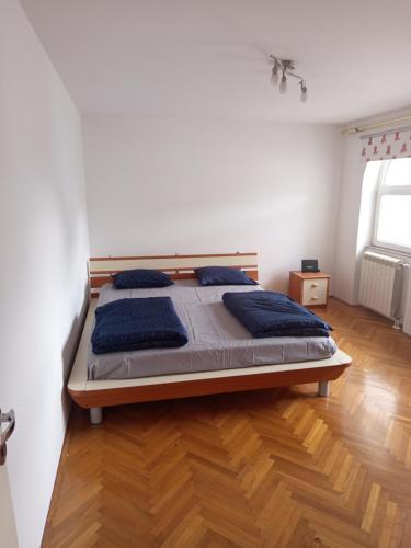 a bedroom with a large bed with blue pillows at Villa Acer in Novi Sad
