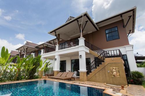 a villa with a swimming pool and a house at The Best Ao Nang Villas in Ao Nang Beach