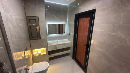 a bathroom with a sink and a toilet and a mirror at Shingelbana Resort in Rawandoz