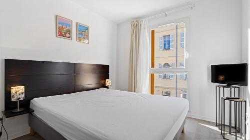 a bedroom with a large bed and a television at Virginia N 410 2P4 in Grasse