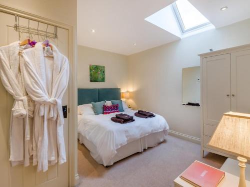 a bedroom with a bed with white sheets and a window at 1 Bed in York oc-g0032 in Crayke