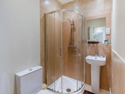 a bathroom with a shower and a toilet and a sink at 1 Bed in York oc-g0032 in Crayke