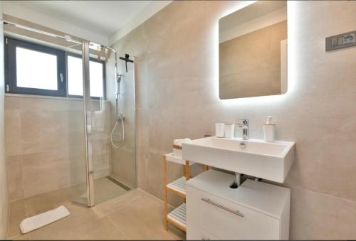 a bathroom with a sink and a shower at Villa Mila in Vabriga