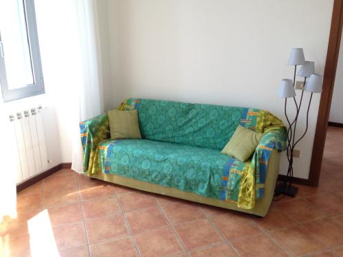 a couch sitting in the corner of a room at Vecchia Filanda Musso 1A in Musso
