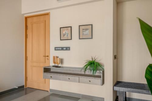 a bathroom with a sink in the corner of a room at Lindsay Manor AkSh Private Pool 4BHK Lift in Arpora