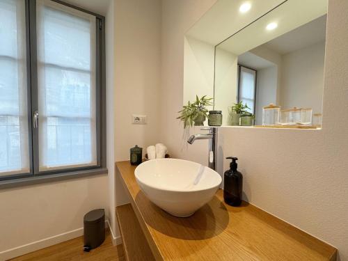 a bathroom with a large white bowl sink on a counter at Carducci Holiday Home in Chiavenna
