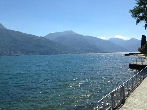a large body of water with mountains in the background at Vecchia Filanda Musso 1A in Musso