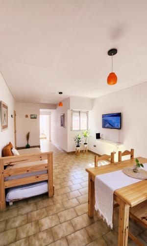 a large room with two beds and a table at PISO UNO - Gran Living Comedor y Habitación - PET FRIENDLY - AUTO CHECK IN 24 HS - Para 4 personas - No alquilamos a Bahienses por el momento in Bahía Blanca