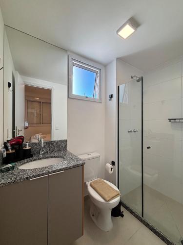 a bathroom with a toilet and a sink and a shower at City Core 2 Bedrooms by AP Smart in Campinas