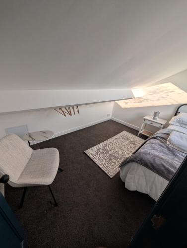 a bedroom with a bed and a chair and a desk at Entire Home in Denton in Denton