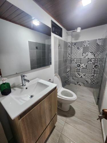 a bathroom with a sink and a toilet at Volterra Guatavita in Guatavita