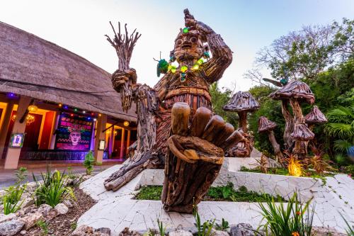 a statue in front of a building at Sandos Caracol Nature Resort & Water Park All Inclusive in Playa del Carmen