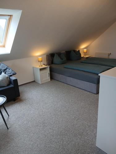 a bedroom with a bed and a couch and a chair at Kranich in Wieck