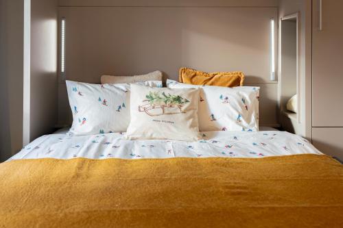 a bedroom with a bed with white sheets and pillows at Superbe Studio Morgins au Pied des Pistes avec Piscine in Morgins