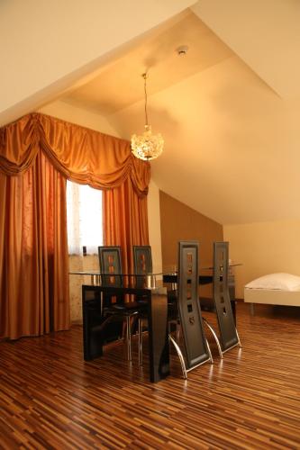 a dining room with a table and chairs at Apartment Kotva in Bratislava