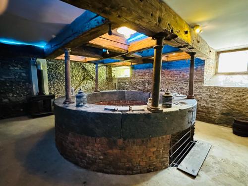 an outdoor kitchen in a room with a brick wall at Moulin de Meeffe in Wasseiges