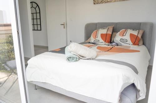 a bedroom with a white bed and a mirror at Villa Champan in La Ciotat