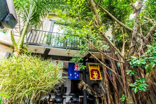 a balcony on a building with a tree at Settle Inn Tourist Lodge in Kandy