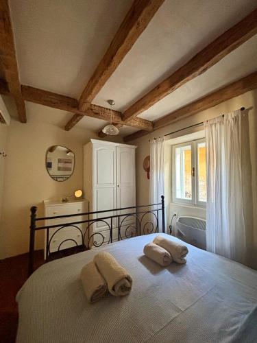 a bedroom with a bed with two towels on it at Franka Apartment in Piran