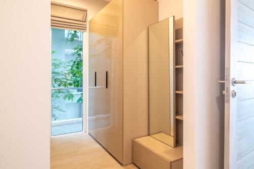 a pivot door in a room with a window at The Residence Seaview in Nathon Bay