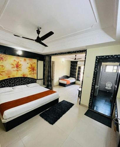 a bedroom with a large bed and a mirror at Hotel amrit in Indore