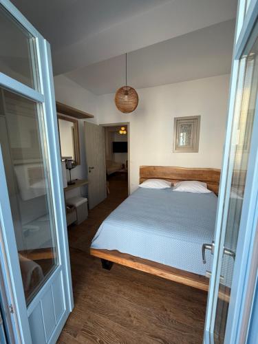 a bedroom with a bed and a glass door at Aristeidis villas in Foiníkion