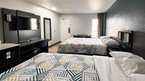 a hotel room with two beds and a bathroom at Studio 6 Suites Lexington, Kentucky in Lexington