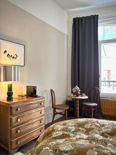 a bedroom with a bed and a dresser and a window at Maison LE 2 in Solre-le-Château