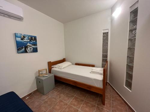 a small bedroom with a bed in a room at Phoenix Cosy Home L in Livadi