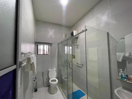 a bathroom with a toilet and a glass shower at The Grace Villa in Abeokuta