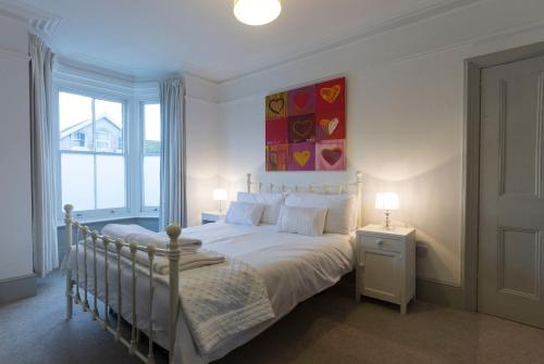 a bedroom with a bed and a large window at Sunshine Villa Broadstairs sleeps 8 close to beach in Broadstairs