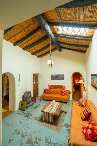 a living room with two beds and a couch at La Rosada, Tilcara in Tilcara
