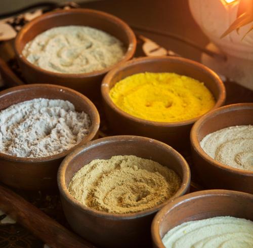 a group of bowls filled with different colored ingredients at Swiss-Belboutique Yogyakarta in Yogyakarta