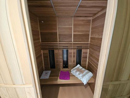 an empty sauna with a purple pillow in a room at Gîtes Prestige LETENDART in Saint-Quentin-en-Tourmont