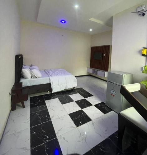 a bedroom with a bed and a checkered floor at The Grace Villa in Abeokuta
