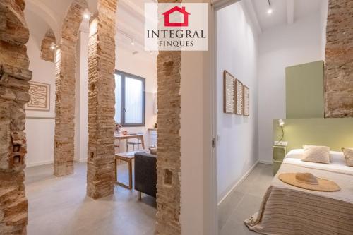 a hotel room with a bed and a sign that reads imperial things at Les Voltes in Palamós