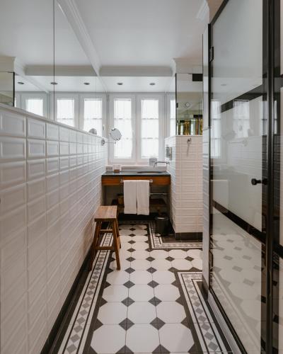 a bathroom with a black and white tiled floor at AlmaLusa Alfama in Lisbon
