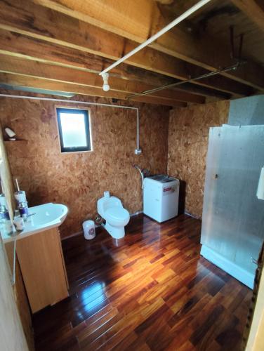 a bathroom with a sink and a toilet in a room at Cabaña Mymemprende in Río Bueno